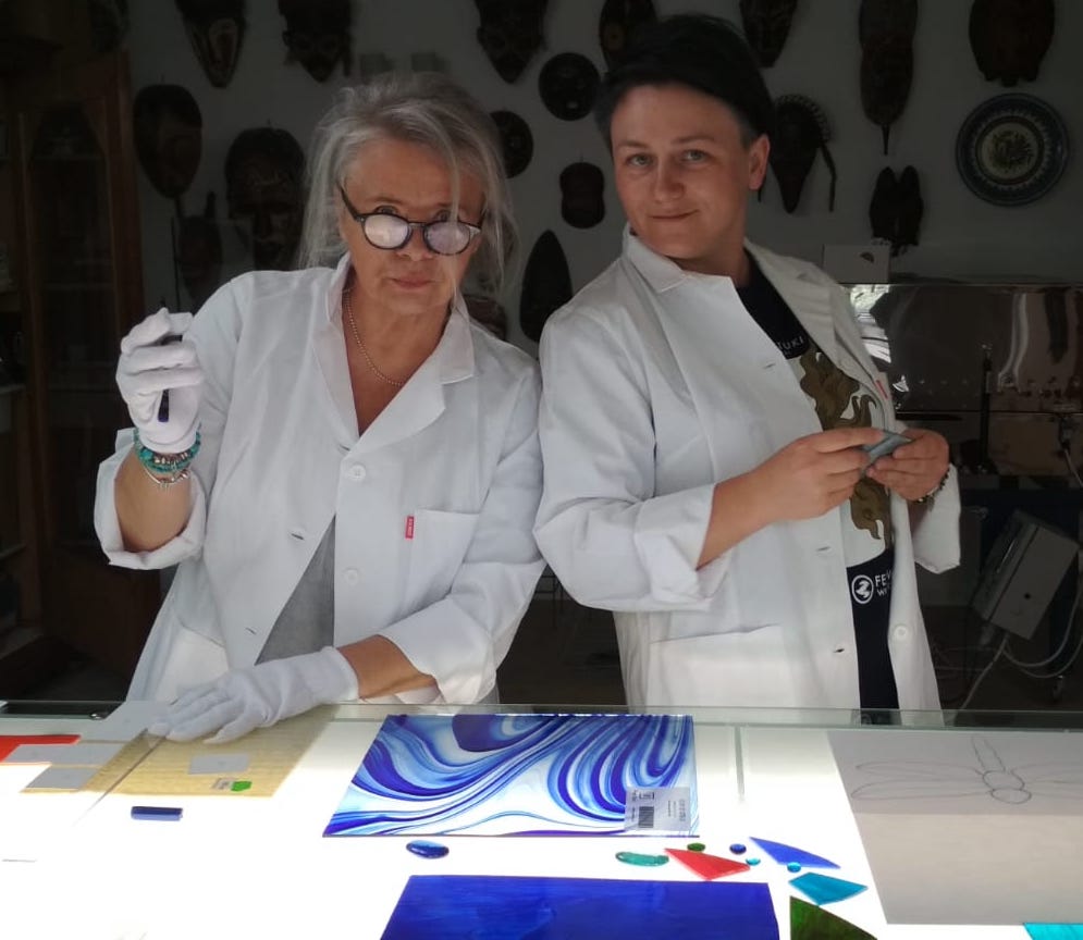 two people working on glass art